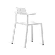 Yard armchair by TOOU Design in a minimalist space, highlighting its timeless geometric design and practical stackable feature.