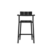 Yard counter stool with arms by TOOU Design in a cafe setup, highlighting its ergonomic design and practical stackable feature.