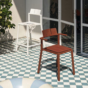 Yard armchair by TOOU Design in a modern patio setup, showcasing its ergonomic design and durable polypropylene material.