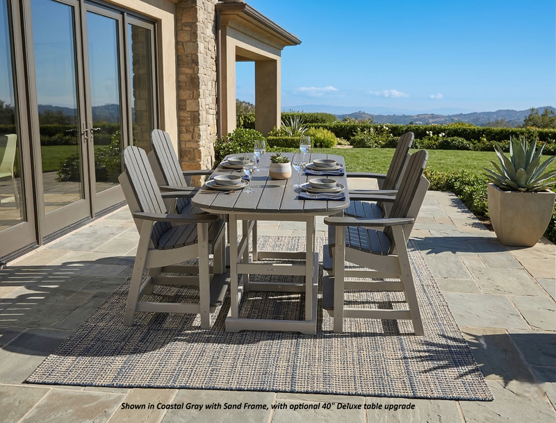 Outdoor Krahn poly bistro set with table and chairs on a patio, featuring a scenic background.
