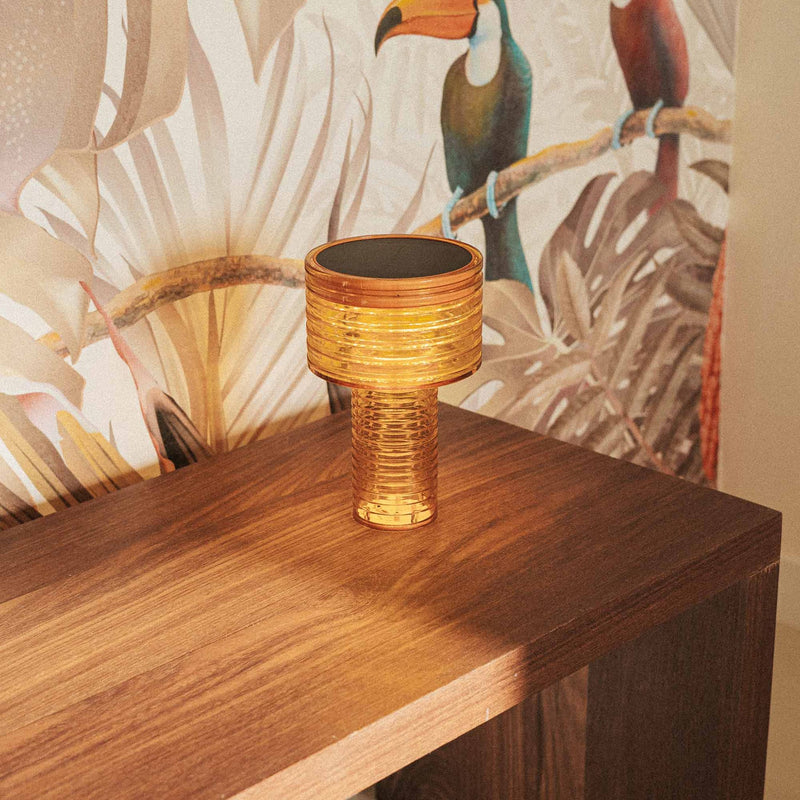 Elegant and compact, Ambar lights patios, balconies, and interiors with solar power and USB-C flexibility.