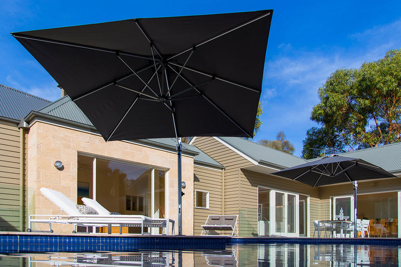 Frankford Cantilever Aurora 9 foot square Umbrella in a pool setting
