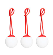 Bolleke Mini set of 3, with red loop, brings warm, portable light to indoor and outdoor spaces.