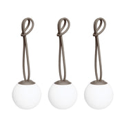 Bolleke Mini set of 3, with taupe loop, brings warm, portable light to indoor and outdoor spaces.