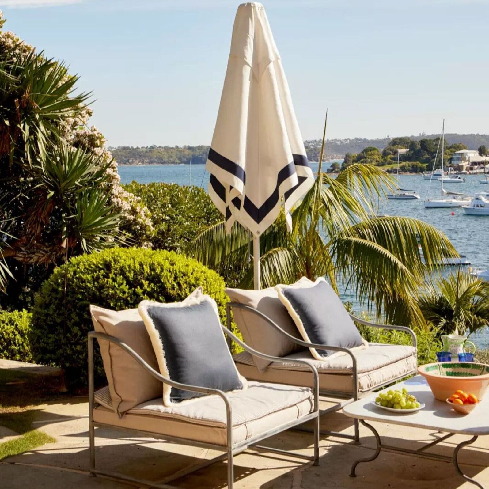 Modern Regatta Patio Umbrella by Basil Bangs with sleek aluminum frame, UPF50+ sun protection, and marine-grade hardware for outdoor use.