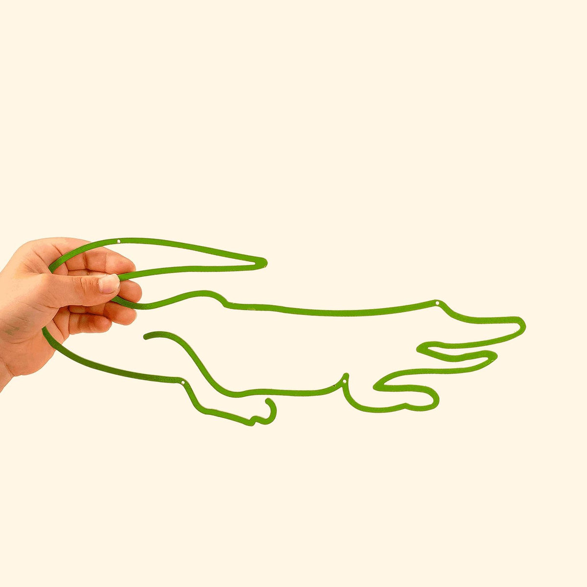 The Crocodile Line: Sleek metal silhouette featuring a playful crocodile, perfect for adding charm to kids&#39; spaces.