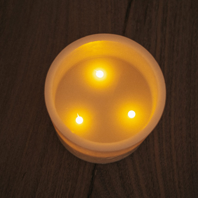 A decorative flameless candle with timer function and remote-controlled lighting.