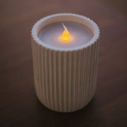 Contemporary candle-style lamp with ceramic coating and gentle LED candlelight.