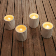 A compact ceramic LED candle offering warm glow, remote control, and timer function.