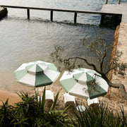 Double Caspar Patio Umbrella with a lofted canopy for airflow, double pulley mechanism, and replaceable components for longevity.