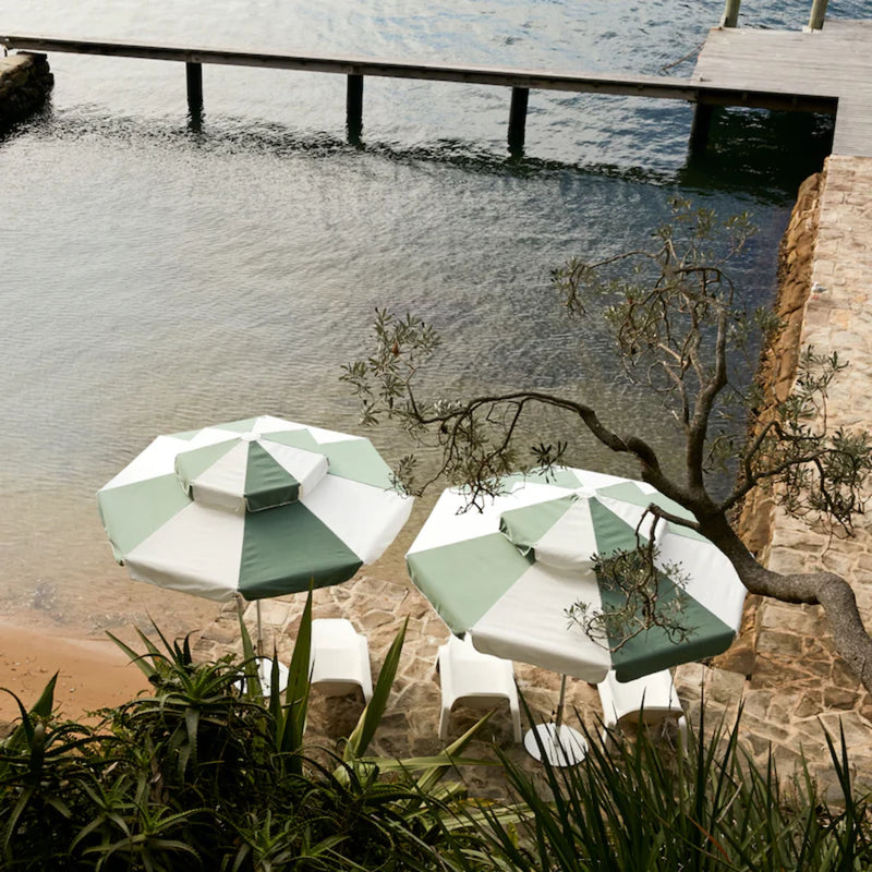 Double Caspar Patio Umbrella with a lofted canopy for airflow, double pulley mechanism, and replaceable components for longevity.