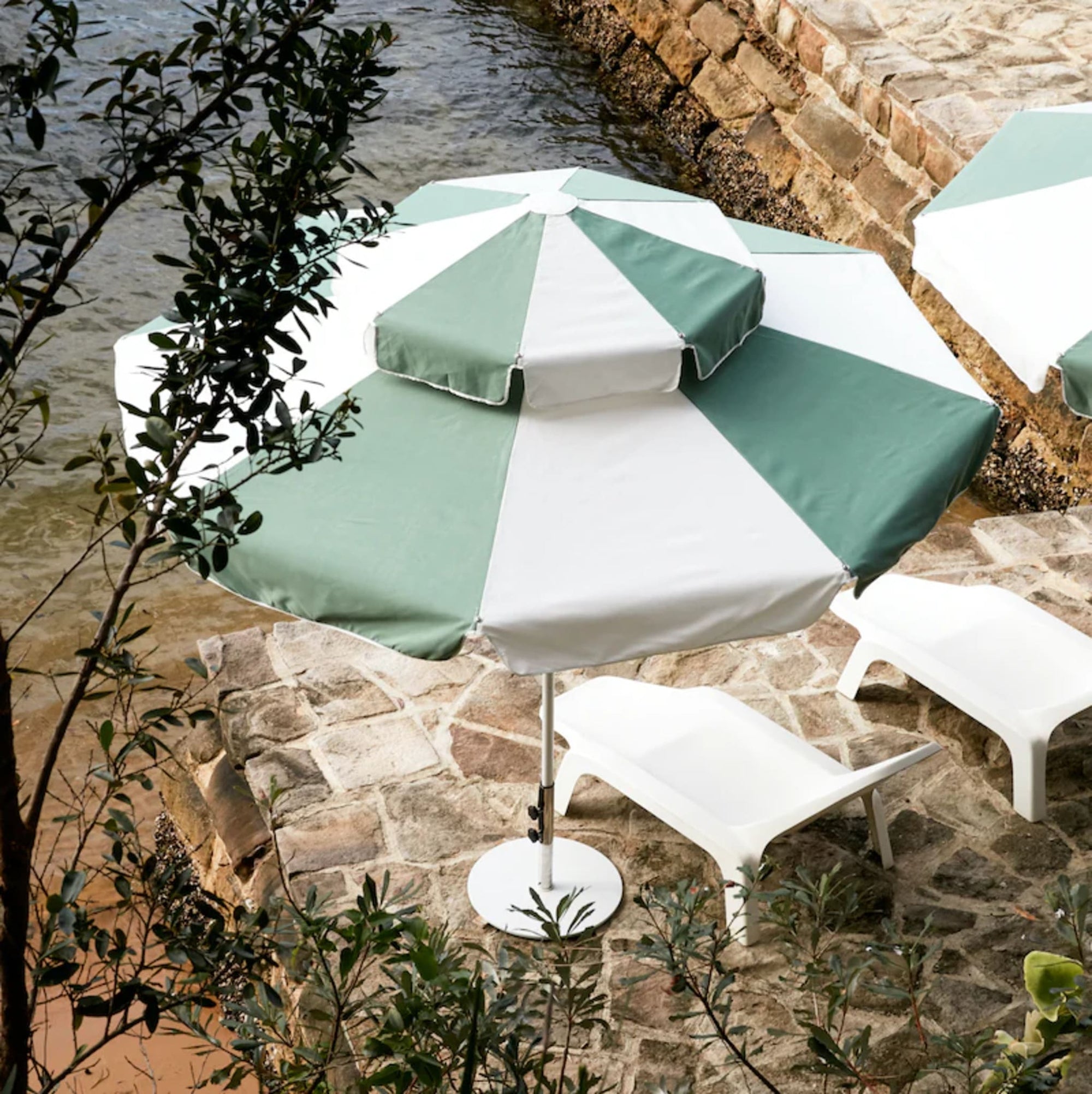 Stylish and durable Double Caspar Patio Umbrella featuring a white powder-coated aluminum frame and marine-grade components.