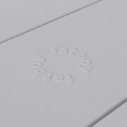 Close-up of Fred’s table by Fatboy in light grey, showcasing its durable aluminum slats for a sleek and weather-resistant finish.