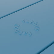 Close-up of Fred’s table by Fatboy in wave blue, showcasing its durable aluminum slats for a sleek and weather-resistant finish.