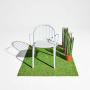 Fred’s Armchair enhancing the look of a contemporary balcony with its sleek, modern aesthetic.