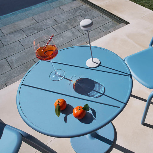 Fred’s Bistreau table by Fatboy on a balcony, showcasing its compact, weather-resistant design for small outdoor spaces.