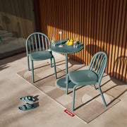 Fred’s Bistreau table with wine glasses, ideal for intimate outdoor dining experiences.