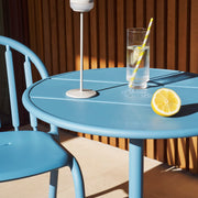 Fred's Bistro Set with a sturdy round table and stackable chairs, offering convenience and comfort for outdoor living.