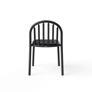 Fred’s Chair with rain droplets draining off the smile-shaped opening, highlighting its smart water-resistant design.