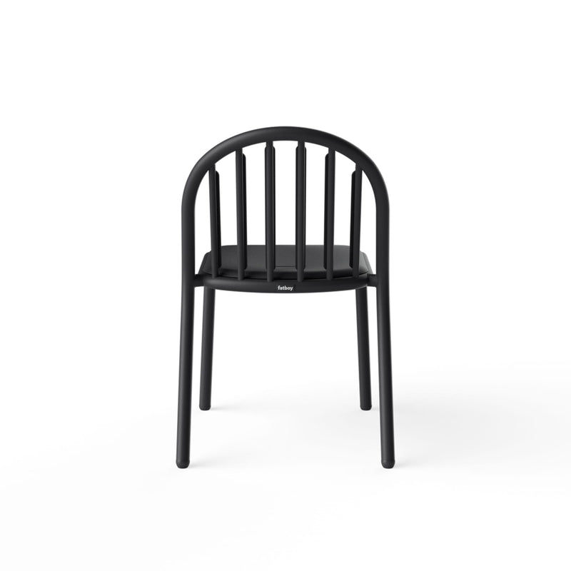 Fred’s Chair with rain droplets draining off the smile-shaped opening, highlighting its smart water-resistant design.