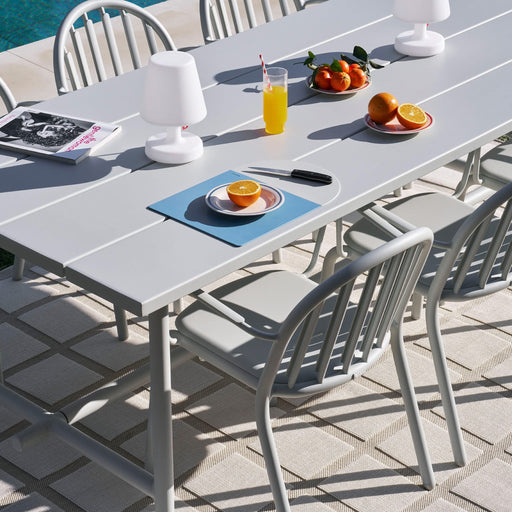 Fred’s Table in a garden setting, featuring a durable aluminum construction built to withstand Canadian weather conditions.