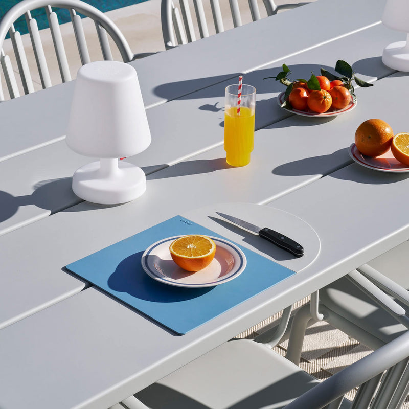 Weather-resistant Fred’s Table under the sun, showcasing its UV-grade 8 protection for long-lasting use.