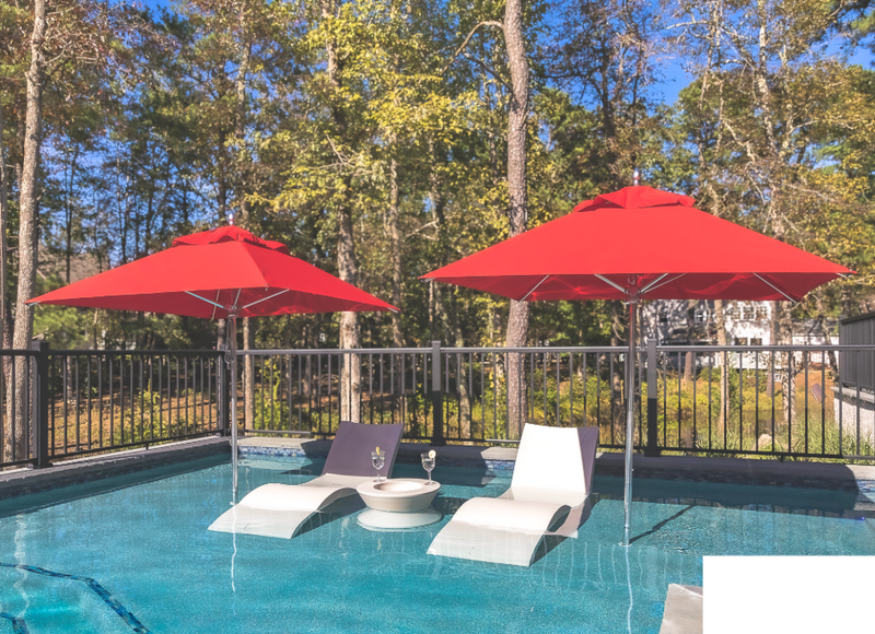 Two Frankford Greenwich Umbrella Square Logo Red in a backyard pool with loungers