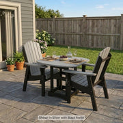 Krahn Dining Table with 2 Classic Dining Chairs shown in Silver with Black frame, on a background stone patio
