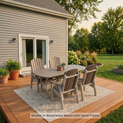 A Krahn Dining Table Set with 4 Classic Dining Chairs, on a Wooden Deck with an area rug, with a siding house and yard in the background