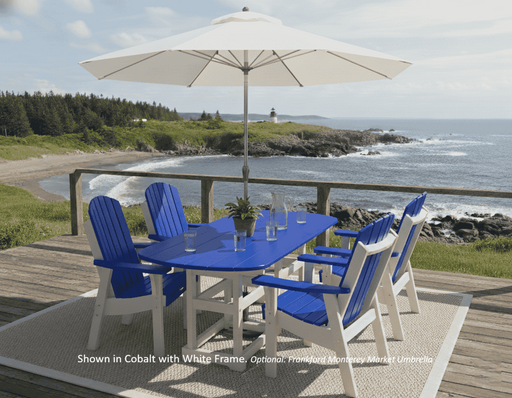 Krahn Outdoor dining set with blue krahn dining hairs and a white Frankford Monterey fiberglass market umbrella on a deck overlooking the ocean.