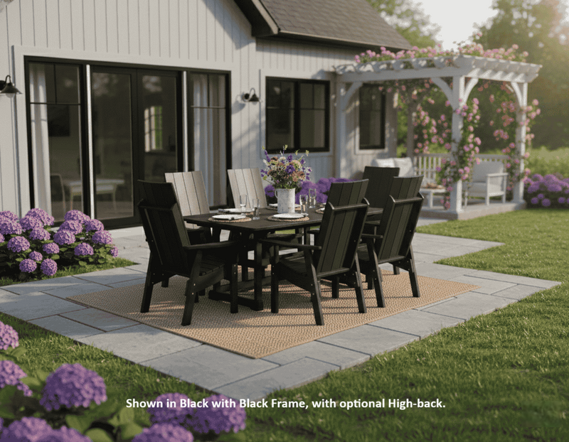 Krahn outdoor deluxe dining set with black modern dining chairs and table on a patio in front of a house.