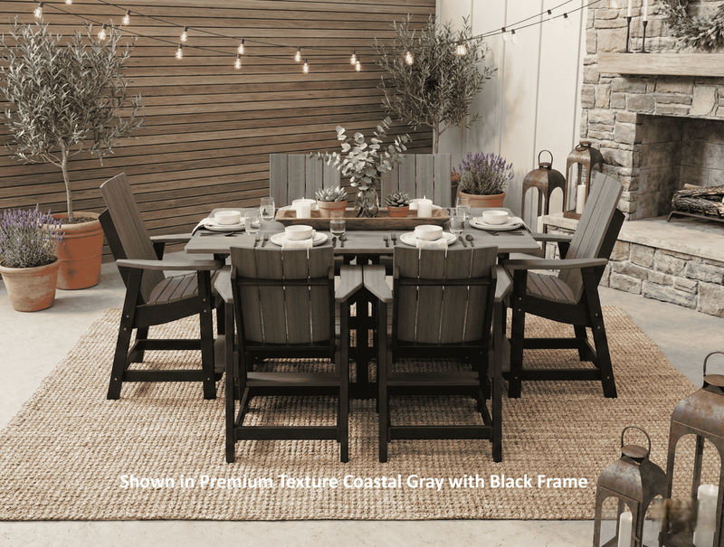 Krahn outdoor poly dining set with chairs and table in a patio setting with plants and a fireplace.