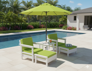 A couple of Deep seat lounge chairs with ottomans by a pool under an umbrella