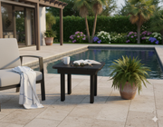 Black Poly Side Table  beside a chair by a pool