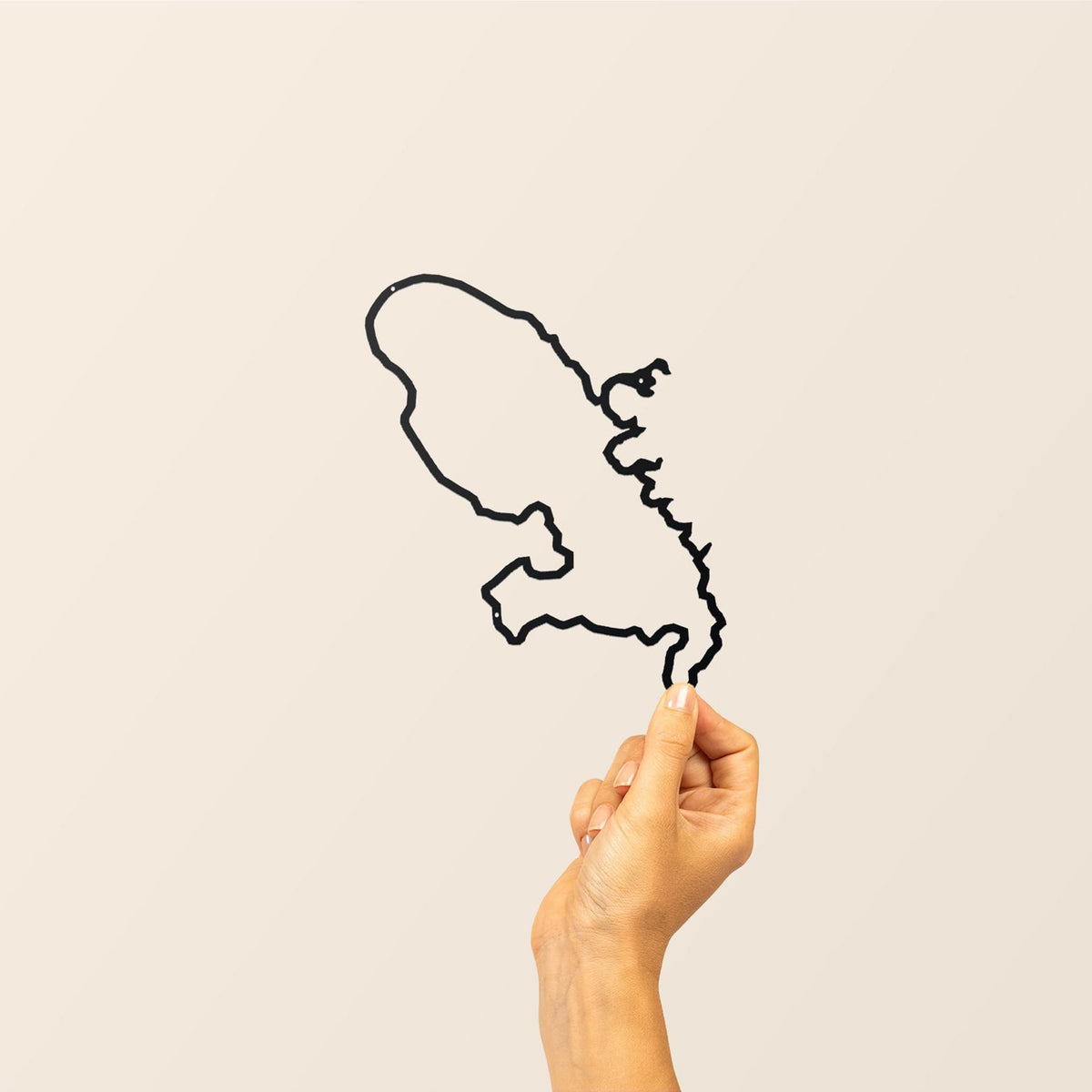 inimalist Island Collection by The Line features elegant island silhouettes, blending style and geographical allure.