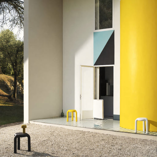 Minimalist Piccolo stool with hollowed-out structure, crafted from durable polypropylene, ideal for versatile spaces.