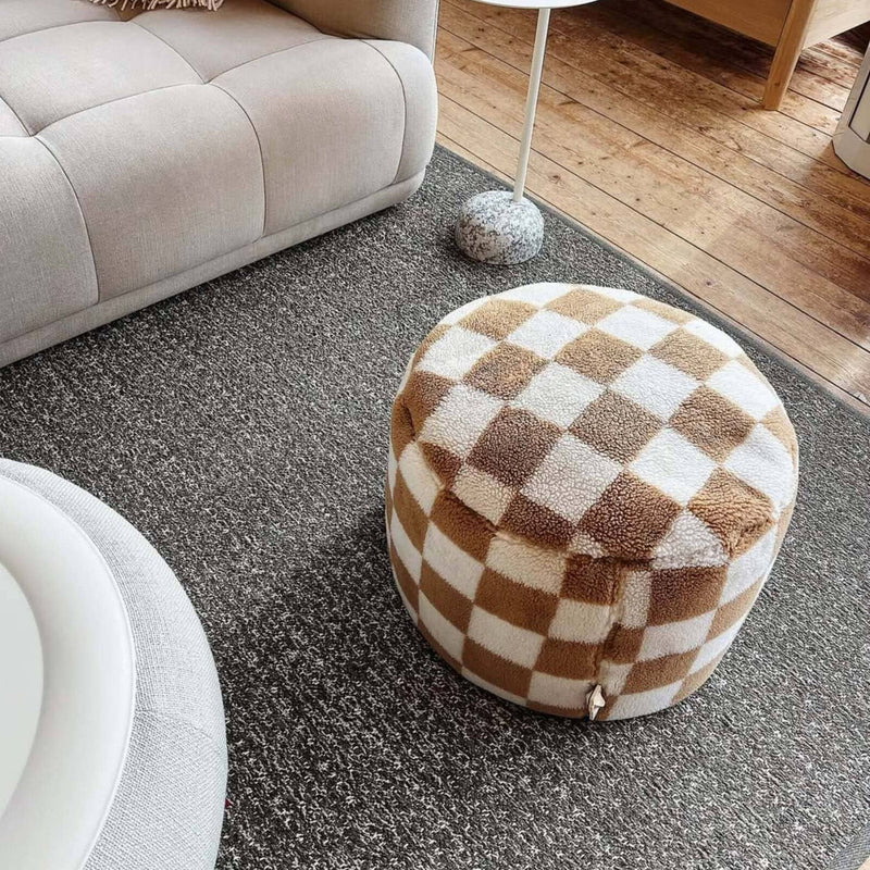 Soft indoor pouf with plush teddy fabric and a bold checkered design, filled in Canada.