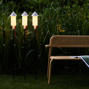 Rocket-shaped Fatboy Prêt-A-Racket lights provide cozy solar-powered illumination for outdoor spaces.