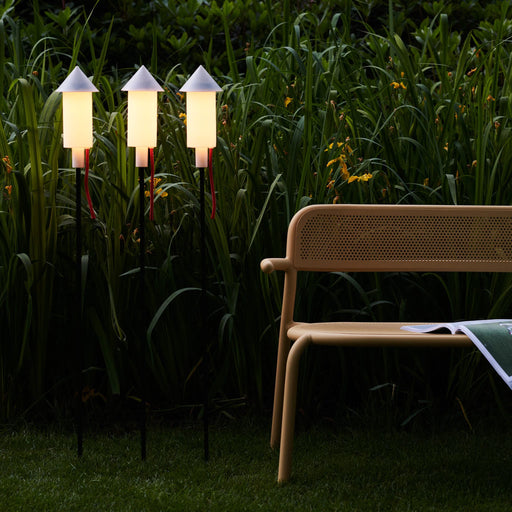 Rocket-shaped Fatboy Prêt-A-Racket lights provide cozy solar-powered illumination for outdoor spaces.
