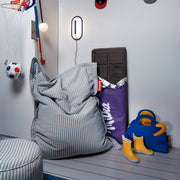 Slim bean bag designed for indoor comfort, playful stripes, and everyday relaxation.