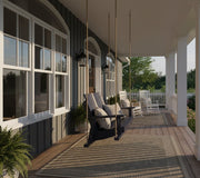 Krahn Porch Swing in Navy Blue hanging from a veranda with pillows on a sunny day