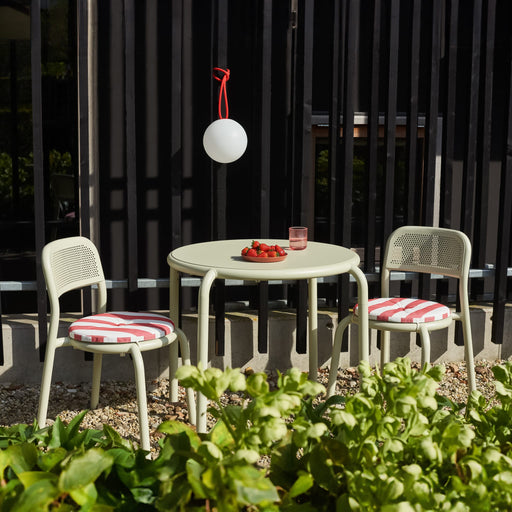 Compact Toní Bistro Set in neutral colors, designed for patios, terraces, and gardens with weather-resistant materials.