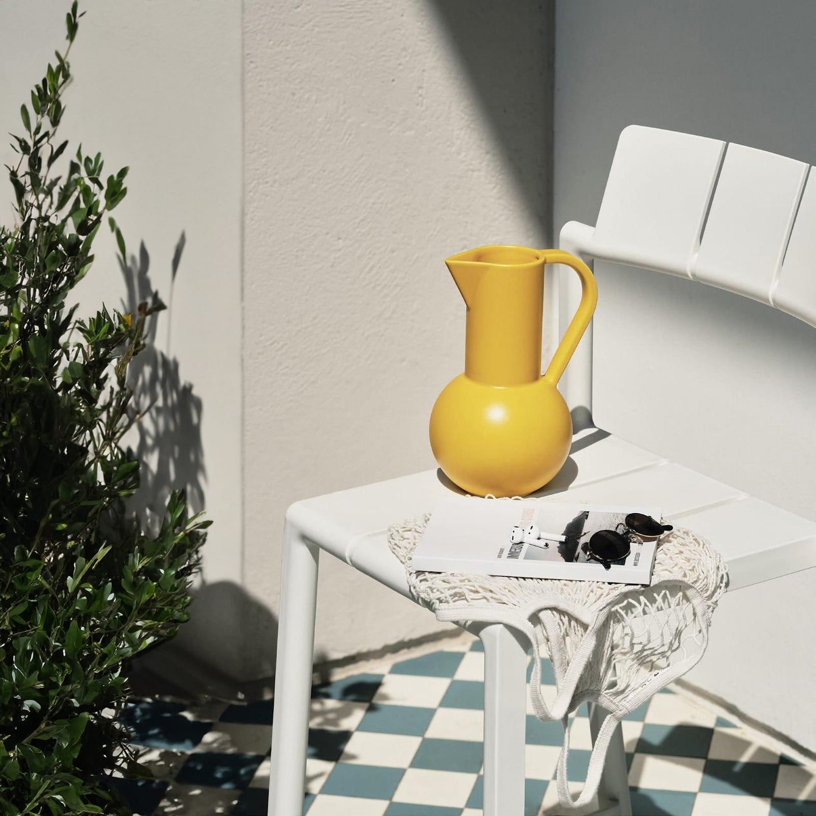 Yard chair by TOOU Design in a modern indoor setting, showcasing its sleek geometric design and durable polypropylene material.