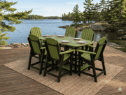 Krahn outdoor bistro set in green with black frame on a wooden deck by a lake with trees in the background